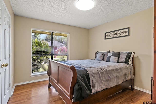 1801 N Fairway, Mount Pleasant, TX 75455 - bedroom with wood finished floors and a textured ceiling