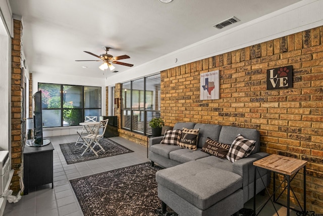 1801 N Fairway, Mount Pleasant, TX 75455 - living area with tile patterned floors, a ceiling fan, and brick wall