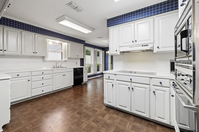 kitchen with a sink, black appliances, light countertops, and white cabinets