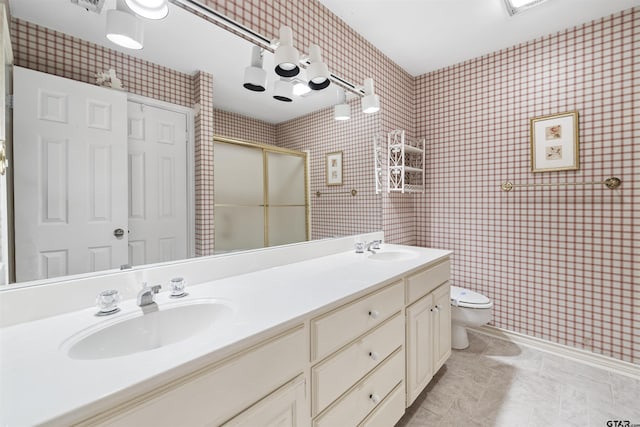 full bathroom with toilet, a stall shower, double vanity, and tile patterned floors