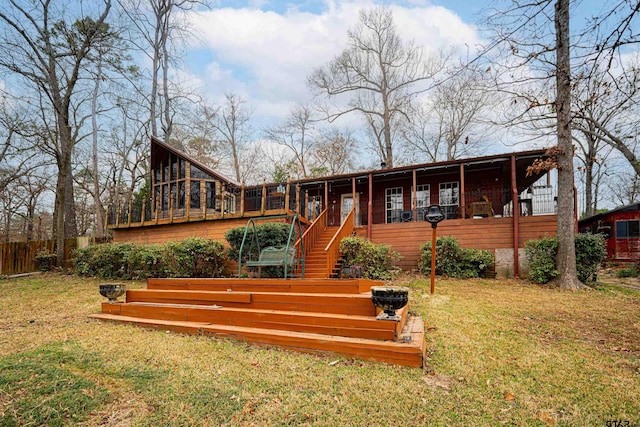 rear view of property featuring a lawn