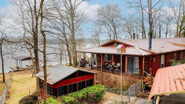 rear view of house featuring a sunroom