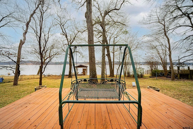 wooden deck with a yard and a water view