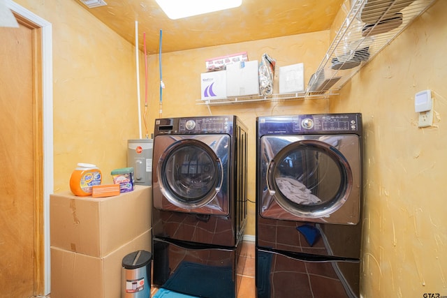 clothes washing area with tile patterned flooring and separate washer and dryer