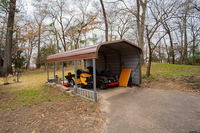 view of outbuilding with a yard and a carport