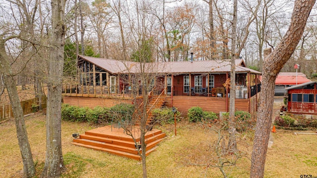 view of front of home featuring a deck and a front yard