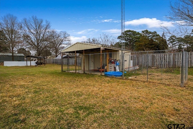 view of yard featuring an outdoor structure and fence