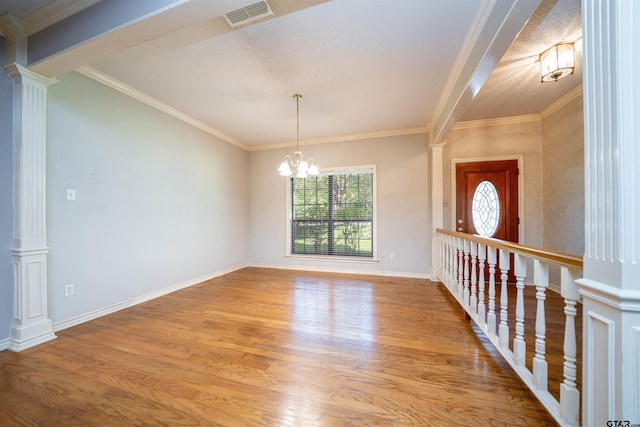 9211 Elm Tree Cir, Tyler, TX 75703 - empty room with ornate columns, wood finished floors, ornamental molding, a chandelier, and baseboards