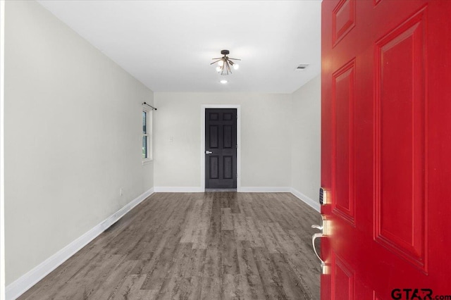 entrance foyer with wood finished floors, visible vents, and baseboards