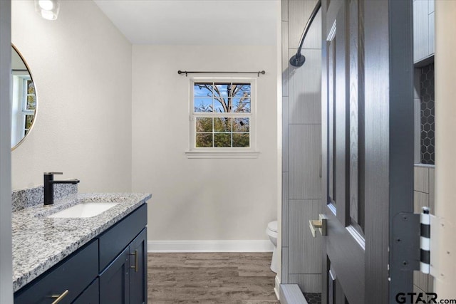 full bath featuring baseboards, vanity, toilet, and wood finished floors