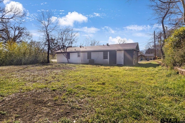 rear view of house with a yard