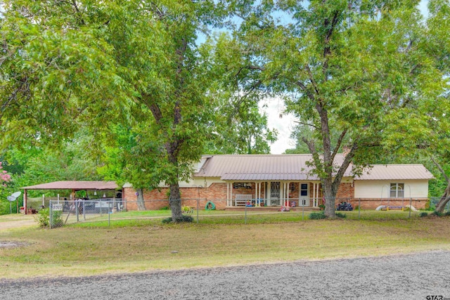 view of front of house featuring covered porch and a front yard