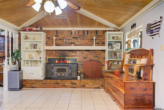 tiled living room with vaulted ceiling with beams, ceiling fan, wood ceiling, and a wood stove