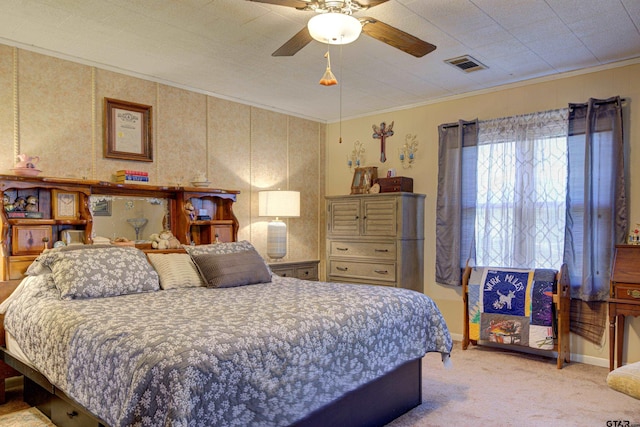 bedroom with light carpet, ceiling fan, and crown molding