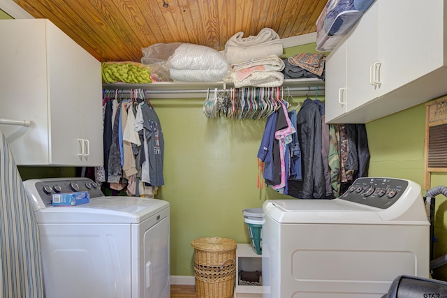 laundry area with cabinets, separate washer and dryer, and wood ceiling