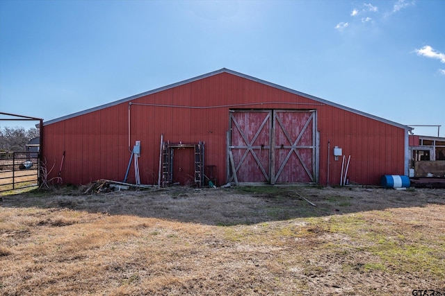 view of pole building with fence