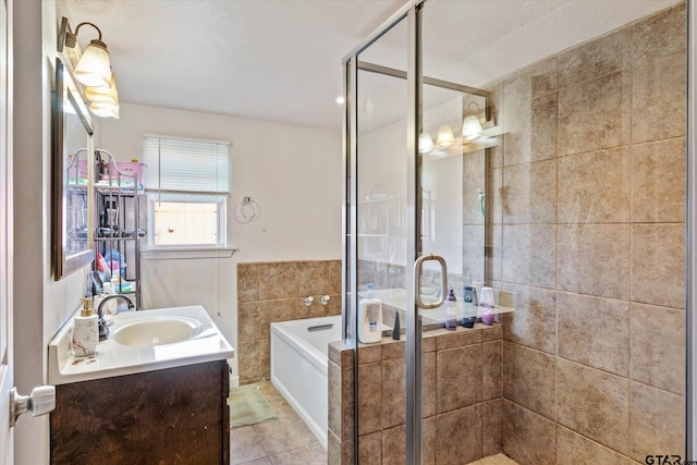 bathroom featuring a bath, tile patterned floors, a stall shower, and vanity