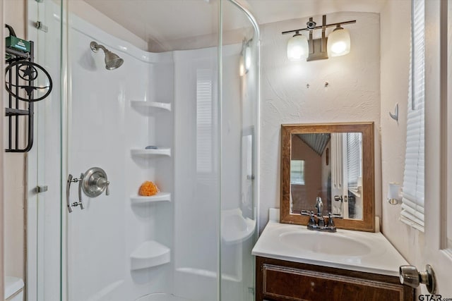 bathroom featuring vanity and a shower stall