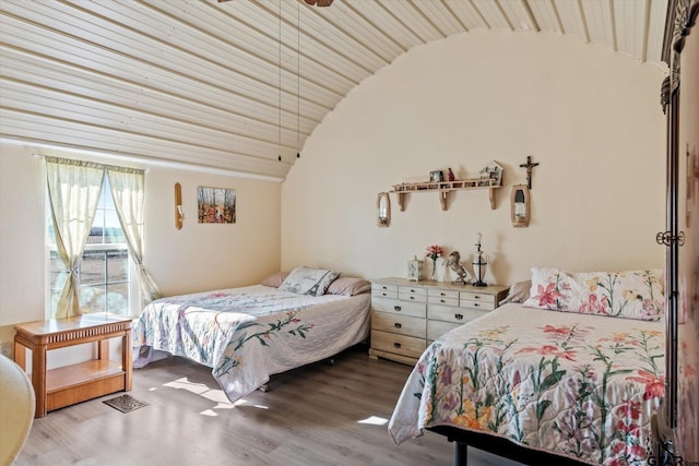 bedroom with lofted ceiling and light wood-type flooring