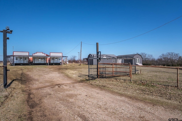 view of road with a gated entry and driveway