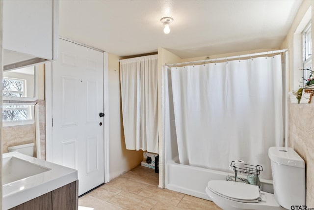 full bathroom with toilet, vanity, and shower / bath combination with curtain