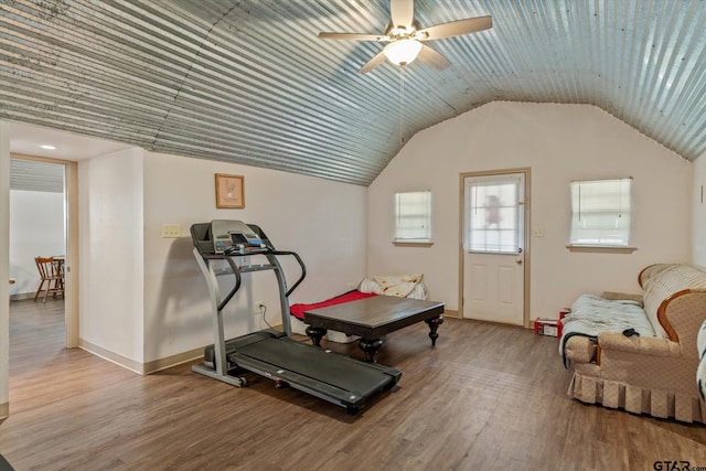 workout room featuring baseboards, lofted ceiling, ceiling fan, and wood finished floors