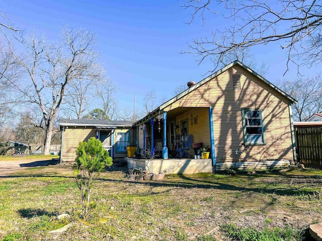 exterior space featuring a porch and a lawn