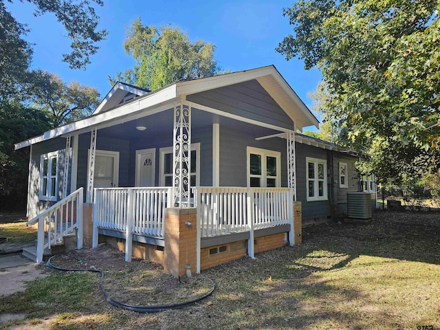 view of front of property featuring central air condition unit and a porch