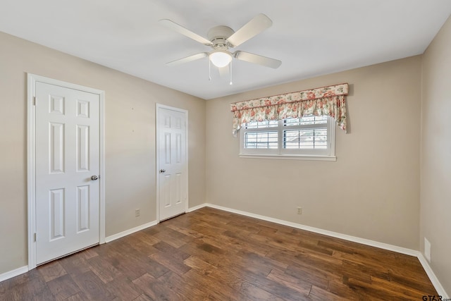 unfurnished bedroom with ceiling fan, baseboards, and dark wood finished floors