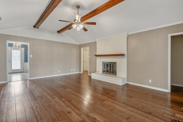 unfurnished living room featuring ceiling fan with notable chandelier, lofted ceiling with beams, baseboards, and hardwood / wood-style floors