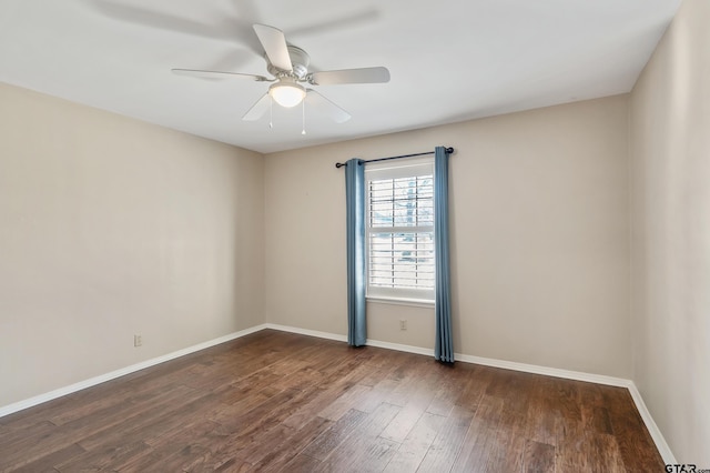 spare room featuring wood finished floors, baseboards, and ceiling fan