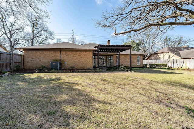 rear view of property featuring fence, a pergola, a chimney, a lawn, and brick siding