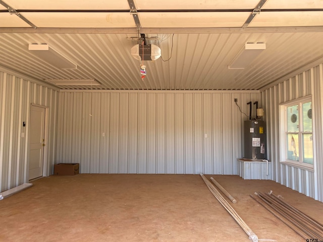 garage with water heater and a garage door opener