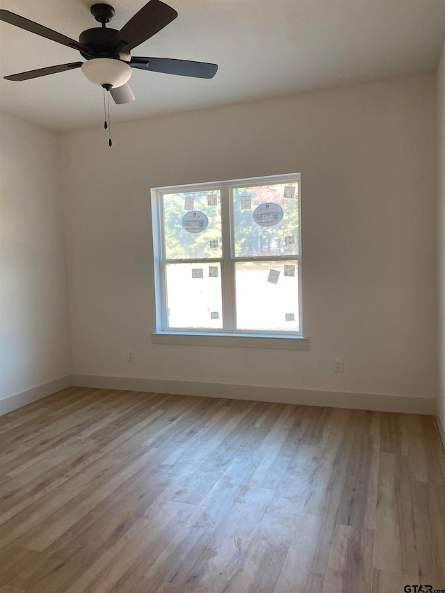 empty room featuring ceiling fan and light wood-type flooring