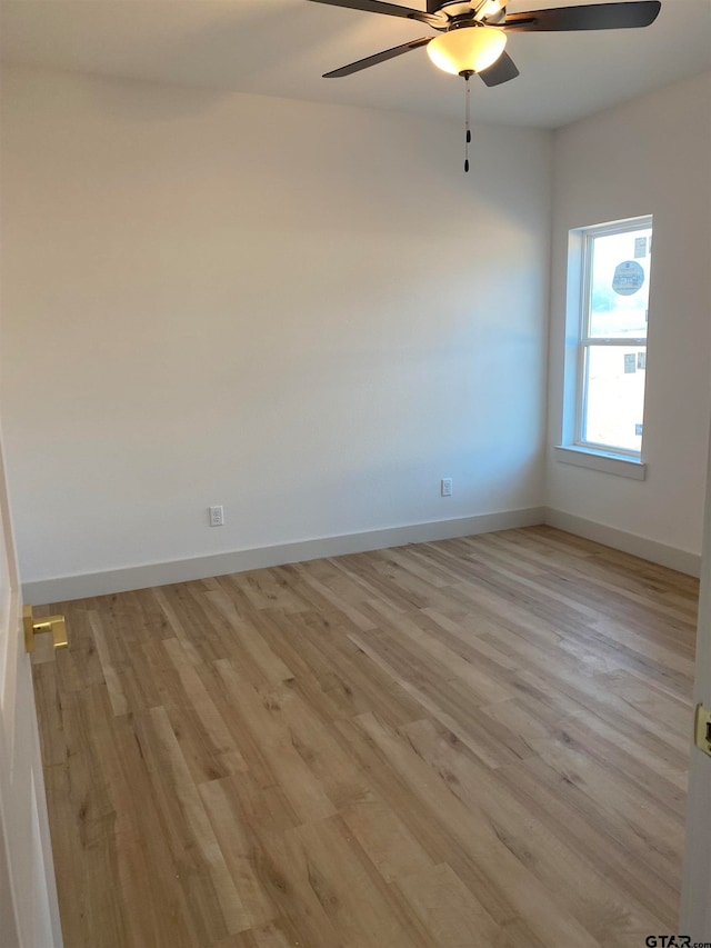 empty room featuring ceiling fan and light hardwood / wood-style flooring