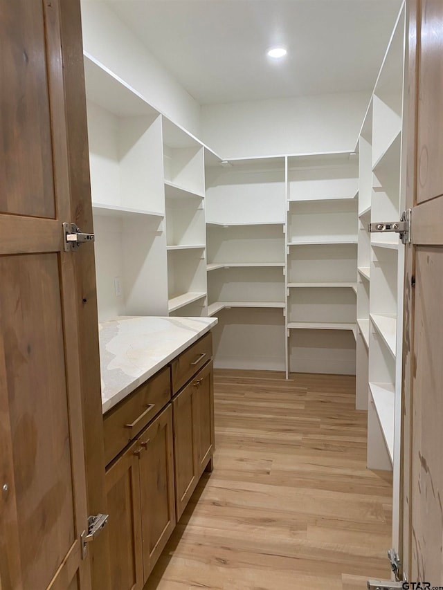 spacious closet featuring light hardwood / wood-style flooring