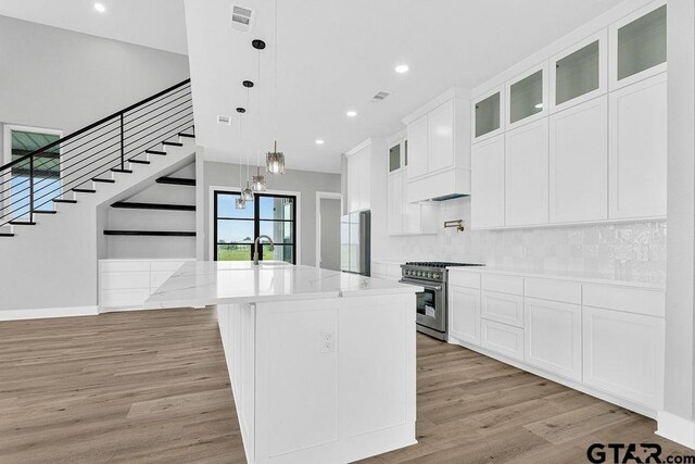 3255 Vz County Road 2120, Canton, TX 75103 - kitchen featuring stainless steel range, light wood-type flooring, white cabinets, recessed lighting, and decorative backsplash