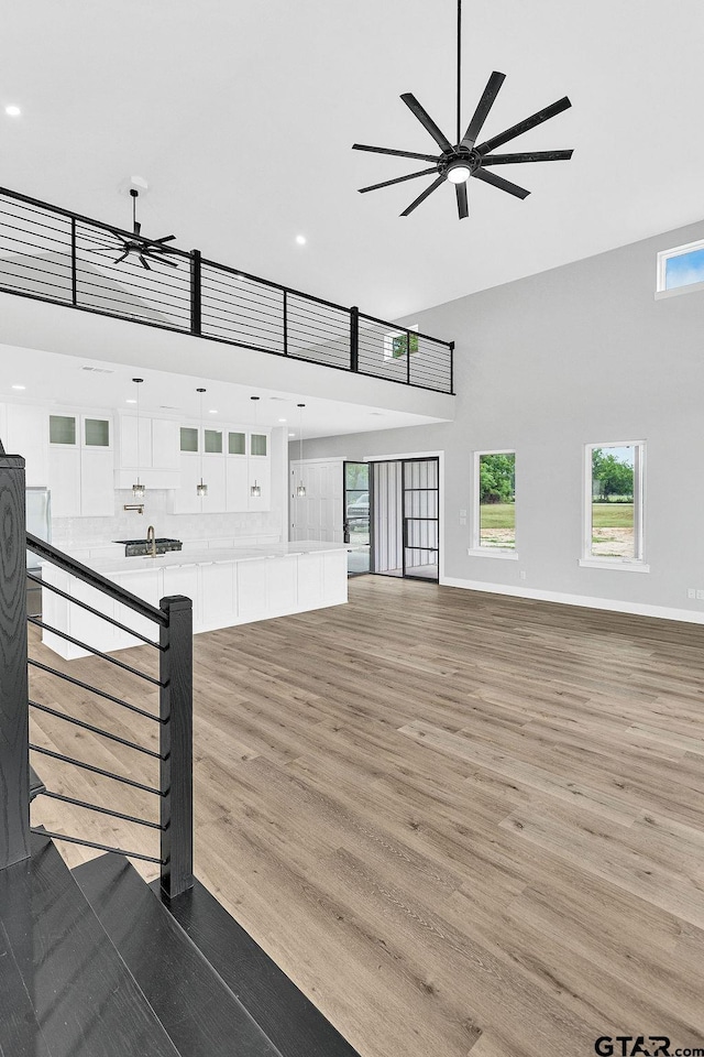 3255 Vz County Road 2120, Canton, TX 75103 - unfurnished living room with a towering ceiling, ceiling fan, light wood-style flooring, recessed lighting, and a sink
