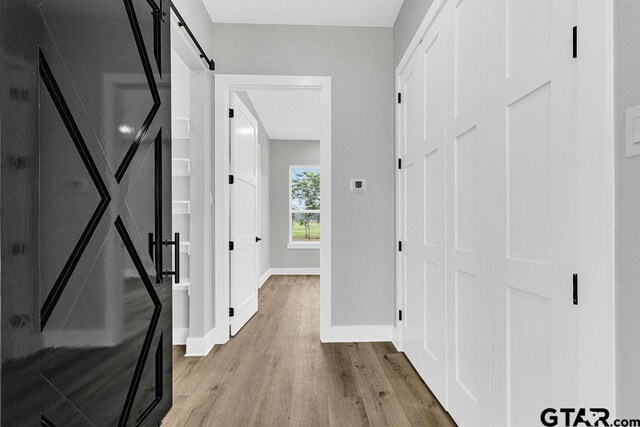 3255 Vz County Road 2120, Canton, TX 75103 - corridor with wood finished floors, a barn door, and baseboards