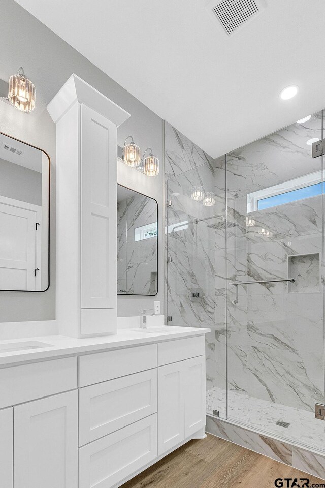 3255 Vz County Road 2120, Canton, TX 75103 - bathroom featuring a marble finish shower, double vanity, wood finished floors, and recessed lighting