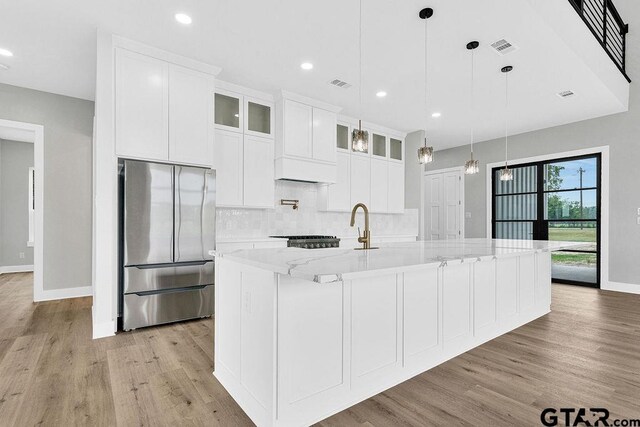 3255 Vz County Road 2120, Canton, TX 75103 - kitchen featuring freestanding refrigerator, light wood-type flooring, baseboards, backsplash, and white cabinetry