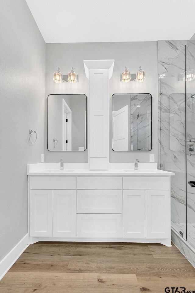 3255 Vz County Road 2120, Canton, TX 75103 - full bath with a marble finish shower, double vanity, wood finished floors, and baseboards