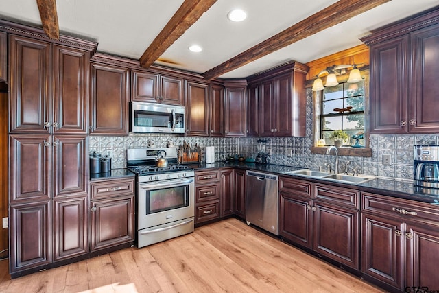 2711 N Fm 250, Hughes Springs, TX 75656 - kitchen featuring appliances with stainless steel finishes, dark countertops, light wood finished floors, beamed ceiling, and tasteful backsplash
