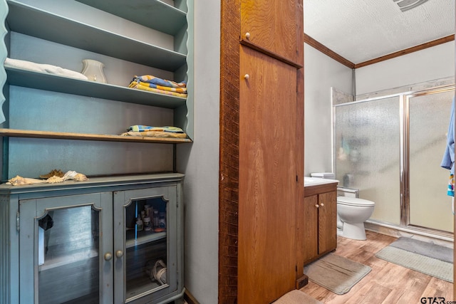 2711 N Fm 250, Hughes Springs, TX 75656 - full bathroom with ornamental molding, wood finished floors, a stall shower, and vanity