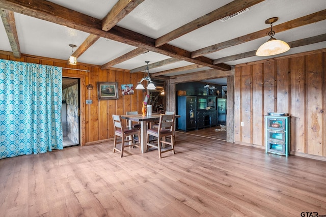2711 N Fm 250, Hughes Springs, TX 75656 - dining space featuring beam ceiling, wood finished floors, and wood walls