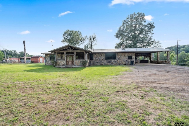 2711 N Fm 250, Hughes Springs, TX 75656 - view of front facade with stone siding, a carport, a chimney, dirt driveway, and a metal roof
