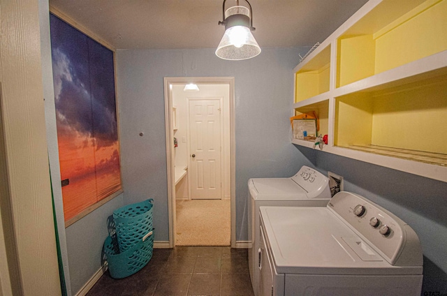 washroom featuring washer and dryer and dark tile patterned floors