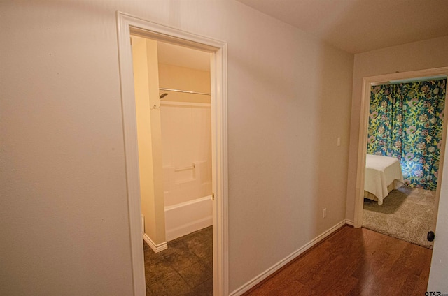 corridor with dark hardwood / wood-style floors