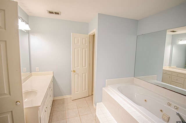 bathroom featuring vanity, tiled bath, and tile patterned floors