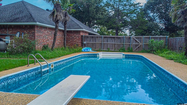 view of pool featuring a diving board